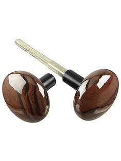 two brown and white marbled wooden knobs with a hair brush in the middle