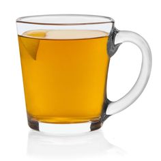 a glass cup filled with liquid on top of a white table