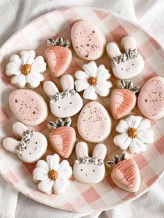 some cookies are on a plate with pink and white decorations