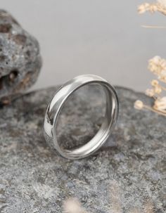 a silver ring sitting on top of a rock