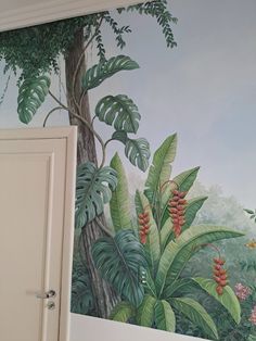 the wall is painted with tropical plants and trees