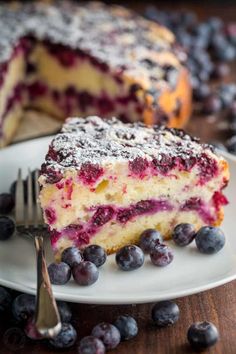 a piece of blueberry cheesecake on a plate with a fork