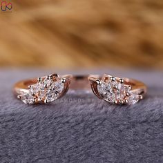 two diamond engagement rings sitting on top of a gray blanket