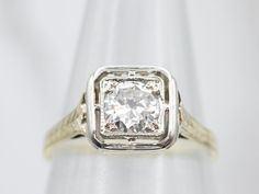 This outstanding piece dates to the late 1910s to 1920s. The filigree framework of the ring is green gold, gold that has been alloyed with silver to give it a pale green hue! The top of the ring is an engraved framework of white gold in a squared-off shape. Set in the center is a beautiful diamond, both protected and accented by the white gold frame and the light coming through the filigree undercarriage. Metal: 14K Green and White GoldGem: Diamond .42 Carats, SI1 in Clarity, G in ColorGem Measurements: 5.0 mm, RoundRing Size: 6Marks: “14K” Stamped on the inside band Bypass Engagement Ring, Gold Diamond Engagement Rings, Engagement Ring Diamond Cut, Round Rings, Diamond Solitaire Engagement Ring, Green Tourmaline, Princess Cut Diamonds, Solitaire Engagement, Diamond Solitaire