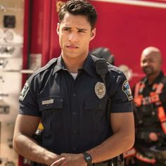 a man standing in front of a fire truck