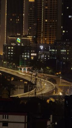 the city skyline is lit up at night