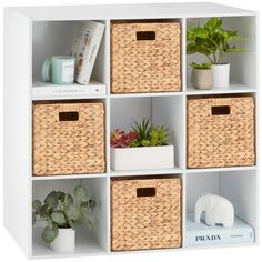 a white shelf with baskets and plants on it's sides, including an elephant figurine