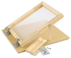 a wooden frame with two screws and some paper in it on a white background