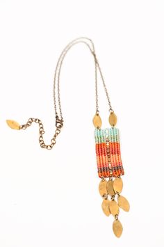 a multicolored beaded necklace with gold coins hanging from it's end