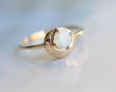 Minimalist Round Cabochon Opal Ring, Delicate White Opal Round Ring, White Ethiopian Opal Ring For Wedding, Delicate White Opal Ring, White Ethiopian Opal Wedding Ring, Minimalist Polished Moonstone Ring For Wedding, Minimalist Moonstone Ring With Polished Finish For Wedding, Ethiopian Opal Moonstone Ring Fine Jewelry, Modern Opal Ring For Anniversary