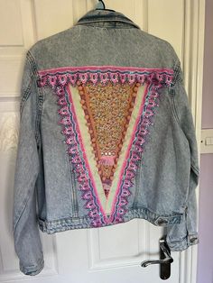 Size uk 14 Beautiful reworked denim jacket with a festival vibe  Size 14 but perfect to wear if you're smaller as an oversized jacket Reworked denim with a decorative back and front. Fabric panel with trimmings, sparkly braid and ribbon Festival Denim Patchwork Outerwear, Summer Patchwork Denim Jacket With Long Sleeves, Hippie Style Outerwear For Spring Festival, Hippie Style Festival Outerwear For Spring, Embroidered Denim Outerwear For Festival, Spring Hippie Patchwork Denim Jacket, Hippie Patchwork Denim Jacket For Spring, Bohemian Long Sleeve Denim Jacket For Spring, Casual Denim Jacket For Winter Festival