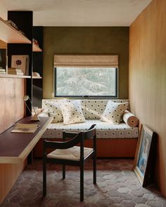 a room with a couch, chair and desk in it