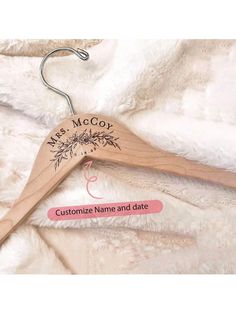 a wooden hanger with the name mrs mccy on it and an image of a flower