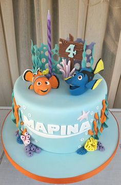 a blue cake decorated with fish and sea life