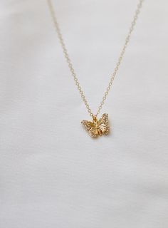 Delicate and sweet, this cubic zirconia butterfly necklace is a larger version to our Miniature CZ Butterfly Necklace . Butterflies symbolize transformation and hope which will make this a beautiful addition to your collection Materials: gold plate with cubic zirconia details Length: 18" gold chain SKU: CN1467G Materials+Care Delicate Jewelry With Cubic Zirconia Butterfly Charm, Delicate Butterfly Jewelry With Cubic Zirconia, Delicate Butterfly-shaped Jewelry With Cubic Zirconia, Delicate Butterfly Cubic Zirconia Jewelry, Delicate Butterfly-shaped Cubic Zirconia Jewelry, Elegant Butterfly Necklace With Cubic Zirconia, Elegant Cubic Zirconia Butterfly Necklace, Dainty Diamond Necklace With Butterfly Charm, Elegant Gold Butterfly Charm Necklace