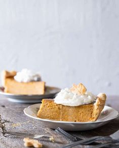 two plates with slices of pumpkin pie on them