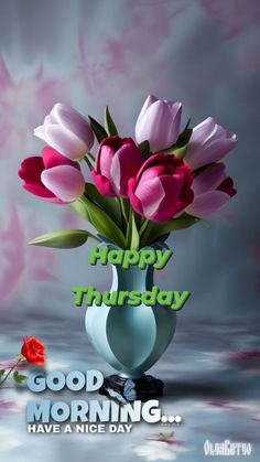 a vase filled with pink tulips on top of a table