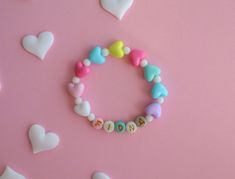 Personalized Kids Bracelet with Colorful Heart-Shaped Spacer Beads 🌈 Brighten Up Their Day with a Touch of Love 🌈 Introduce your little one to the world of fun and fashion with our Personalized Kids Bracelet, adorned with vibrant heart-shaped spacer beads. This playful accessory is perfect for adding a splash of color and joy to any outfit. 💖 Colorful Heart-Shaped Spacer Beads 💖 Each bracelet is crafted with a delightful assortment of colorful heart-shaped beads, making it a cheerful and eye Playful Heart-shaped Letter Beads Bracelet, Heart-shaped Multicolor Bracelets For Mother's Day, Cute Heart Beads Friendship Bracelets For Valentine's Day, Cute Friendship Bracelets For Birthday, Cute Friendship Bracelets With Round Beads For Birthday, Cute Beaded Heart Bracelet For Valentine's Day, Birthday Beaded Bracelets With Heart Beads, Cute Heart Bracelet With Letter Beads, Cute Friendship Bracelets With Round Beads For Birthdays