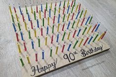 a birthday card with candles arranged in the shape of a number on top of it