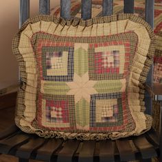 a quilted pillow sitting on top of a chair