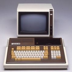 an old computer sitting on top of a white table next to a keyboard and mouse