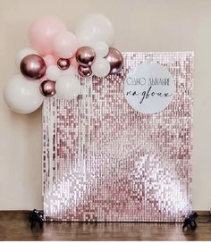 a pink and white balloon filled with helium balloons in front of a gold sequin backdrop