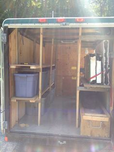 the inside of a storage shed with shelves and bins