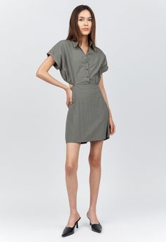 One size. Fits XS-M Color: Green Gray 100% Nylon Folded Short Sleeve Dress Mini Length One Size Collared V-Neck Button-Down Detailing Open-Back Elastic Waist Lightweight Water-Resistant Material Dry Clean or Hand Wash Separately By The NKC Store. Product Measurements: Shoulders: 40.64cm / 16in Bust: 101.6cm / 40in Waist: 104.14cm / 41in Length: 78.74cm / 31in Model is 167cm/ 5'6" wearing Size O/S Casual Fitted V-neck Dress For Daywear, Versatile Fitted V-neck Midi Dress, V-neck Shirt Dress With Button Closure For Work, Casual V-neck Shirt Dress For Work, Green V-neck Shirt Dress, Fitted Green V-neck Shirt Dress, Versatile Mini Spring Dresses, Casual Fitted V-neck Dress For Work, Versatile V-neck Fitted Dress