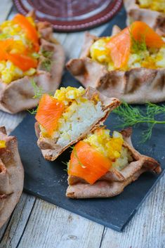 some food is sitting on top of a slate board and ready to be eaten by someone