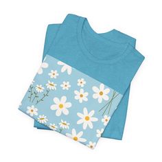 Sky Blue Daisy T - Shirt - T - Shirt - Kristine Celestine Blue Cotton T-shirt For Summer, Light Blue Cotton T-shirt With Graphic Print, Blue Crew Neck Shirt With Floral Print, Blue Floral Print Crew Neck Shirt, Light Blue Crew Neck Shirt For Spring, Light Blue Cotton T-shirt For Spring, Light Blue Cotton Shirt With Floral Print, Blue Relaxed Fit T-shirt For Spring, Blue Floral Print Cotton Tops