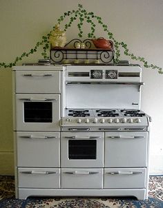 an old fashioned white stove and oven in a room