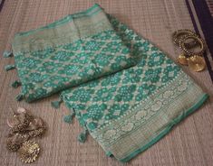 A spectacular Handwoven Sea Green Pure Banarasi Khaddi Georgette Bandhani Saree in gorgeous pattern. Its a fusion of karigari of Banarasi and Gujarati. Additional Information Color : Sea Green Technique: Bandhani is a tye & dye technique in which fabric is pinched with nails and tied with thread and then dyed to create fabulous patterns. Fabric: Pure Georgette Blouse Piece: Included Since this product is handwoven, there might be slight irregularities. But doesn't that add to the singular charm Bohemian Designer Dupatta With Traditional Patterns, Bohemian Choli With Zari Weaving For Traditional Ceremonies, Traditional Bandhani Print Wear In Pista Green For Festivals, Pista Green Traditional Wear With Bandhani Print For Festivals, Pista Green Bandhani Traditional Wear For Festivals, Festive Pista Green Traditional Wear With Bandhani Print, Bohemian Banarasi Silk Choli With Cutdana, Pista Green Bandhani Print Dupatta For Festivals, Pista Green Bandhani Print Dupatta For Festive Occasions