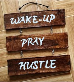 three wooden signs that say wake - up, pray and hustle on the floor