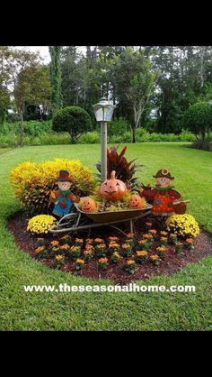 a wheelbarrow filled with pumpkins and gourds in the middle of a garden