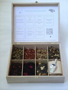 a wooden box filled with lots of different types of tea