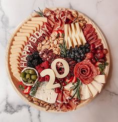 a birthday platter with cheese, fruit and nuts