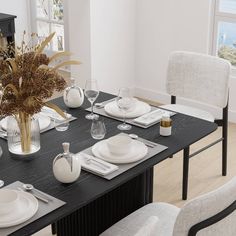 a dining room table set with place settings