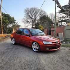 a red car parked on the side of a road