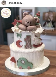 a baby's first birthday cake with a teddy bear on top