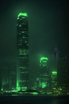 the city skyline is lit up in green for st patrick's day