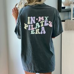 the back of a woman's shirt that says in my pilates era