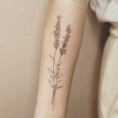 a close up of a person's arm with flowers on it