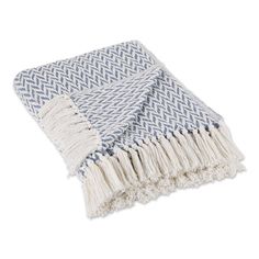 a blue and white throw with fringes on it's edges, sitting on a white surface