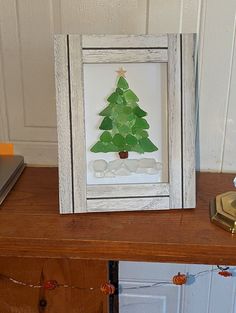 a christmas tree made out of paper sitting on top of a wooden table