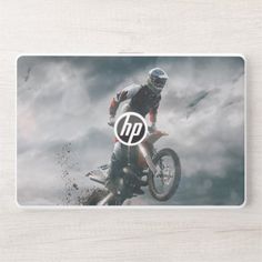 a person on a dirt bike jumping in the air with clouds behind them mouse pad