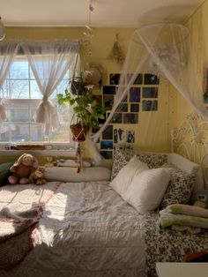 a bedroom with yellow walls and white curtains