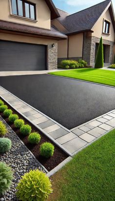 a large driveway with landscaping in front of it