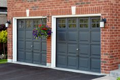 two garage doors with flower boxes on each side