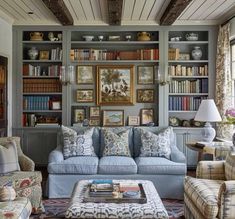 a living room filled with furniture and bookshelves covered in lots of bookcases