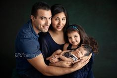 a man, woman and child are posing for a photo with their arms around each other